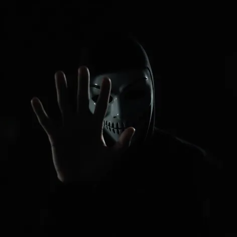 masked guy with hand